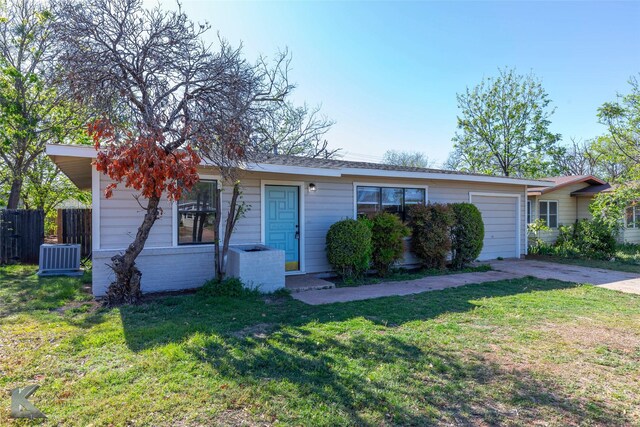 2326 N Mockingbird Ln, Abilene, TX 79603 - view of front facade with concrete driveway, an attached garage, and central AC