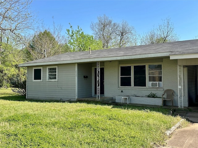 ranch-style house with brick siding and a front lawn