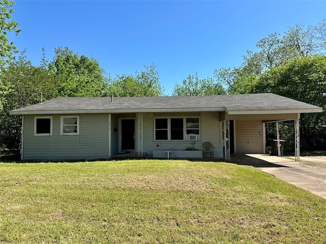 ranch-style house featuring an attached carport, driveway, and a front yard