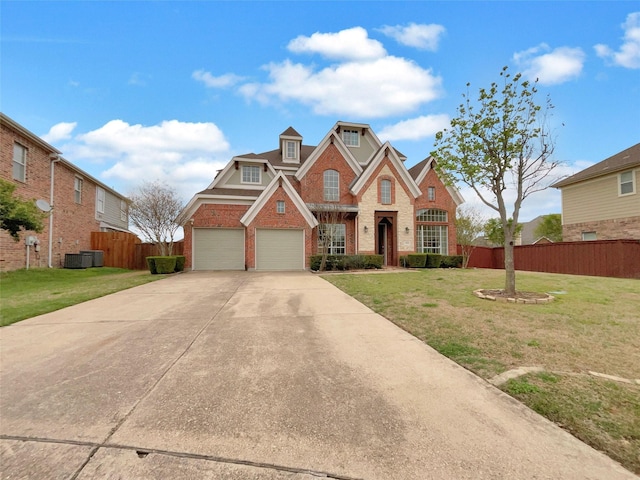 view of front of house with driveway, an attached garage, a front yard, brick siding, and fence