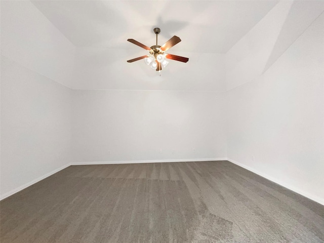 unfurnished room with ceiling fan, dark colored carpet, baseboards, and lofted ceiling