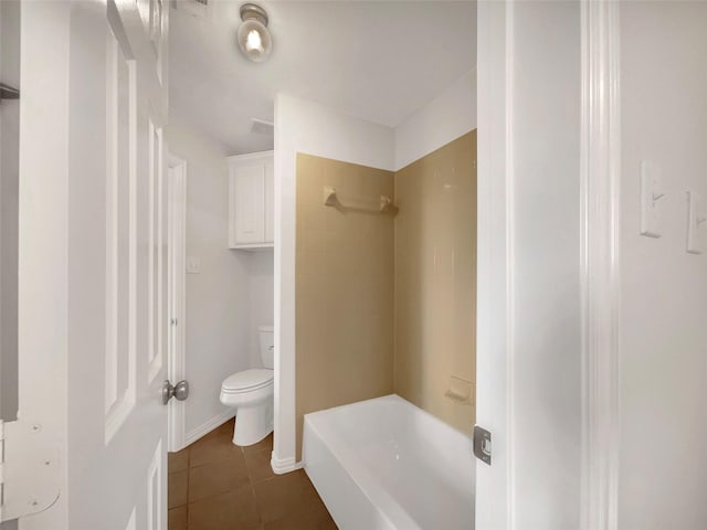 bathroom featuring toilet, shower / bathing tub combination, and tile patterned flooring
