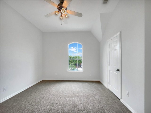 unfurnished room with carpet floors, ceiling fan, vaulted ceiling, and baseboards