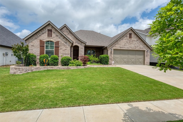 616 Point Vista Dr, Aledo, TX 76008 - french country home with concrete driveway, a front lawn, an attached garage, and brick siding