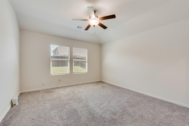empty room featuring ceiling fan, baseboards, visible vents, and carpet