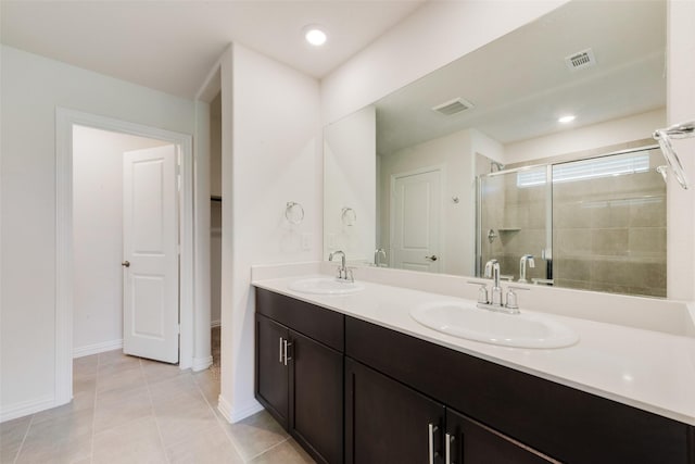 full bathroom featuring visible vents, a sink, and a stall shower