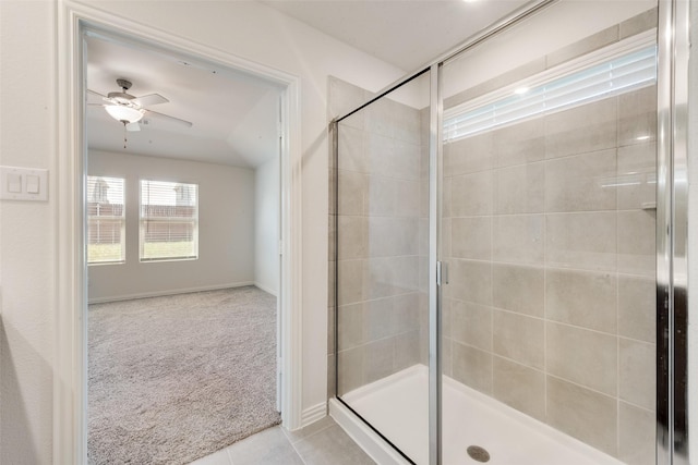 bathroom with a shower stall, baseboards, a ceiling fan, and tile patterned floors