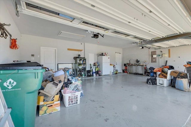 1102 Brigham Dr, Forney, TX 75126 - garage with freestanding refrigerator, a garage door opener, and electric panel