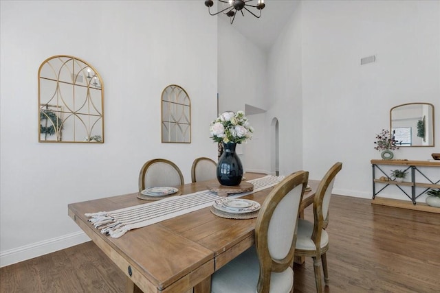 1102 Brigham Dr, Forney, TX 75126 - dining area featuring high vaulted ceiling, a chandelier, baseboards, wood finished floors, and arched walkways