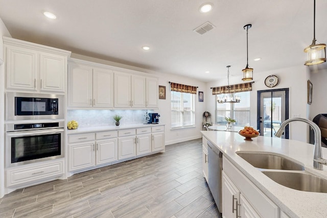 1979 Frediano Ln, Mclendon Chisholm, TX 75032 - kitchen with hanging light fixtures, appliances with stainless steel finishes, visible vents, and a sink