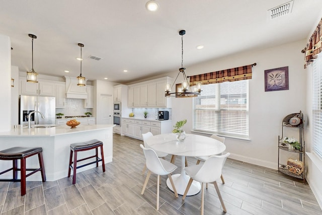 1979 Frediano Ln, Mclendon Chisholm, TX 75032 - dining area featuring recessed lighting, light wood-type flooring, visible vents, and a notable chandelier