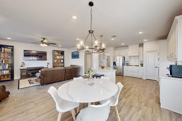 1979 Frediano Ln, Mclendon Chisholm, TX 75032 - dining area with light wood-type flooring, visible vents, ceiling fan with notable chandelier, and recessed lighting