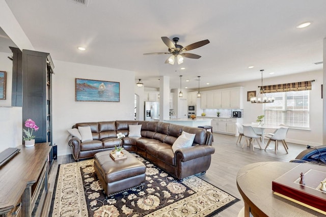 1979 Frediano Ln, Mclendon Chisholm, TX 75032 - living area with baseboards, light wood-style flooring, ceiling fan with notable chandelier, and recessed lighting
