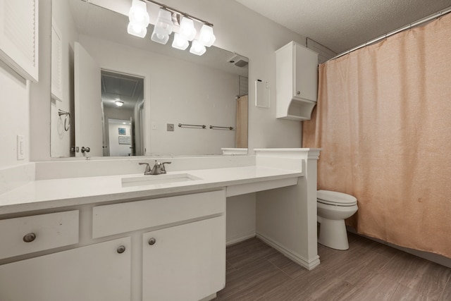 bathroom with wood finished floors, toilet, and vanity