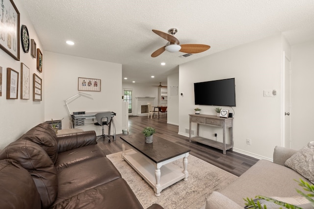 living area featuring a textured ceiling, visible vents, recessed lighting, wood finished floors, and ceiling fan