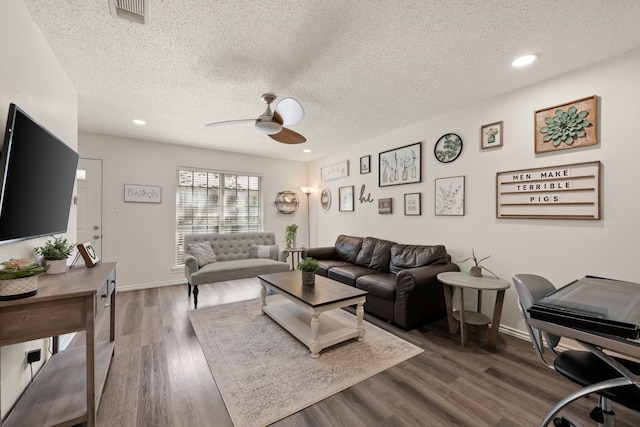 living area with dark wood finished floors, visible vents, baseboards, a textured ceiling, and ceiling fan