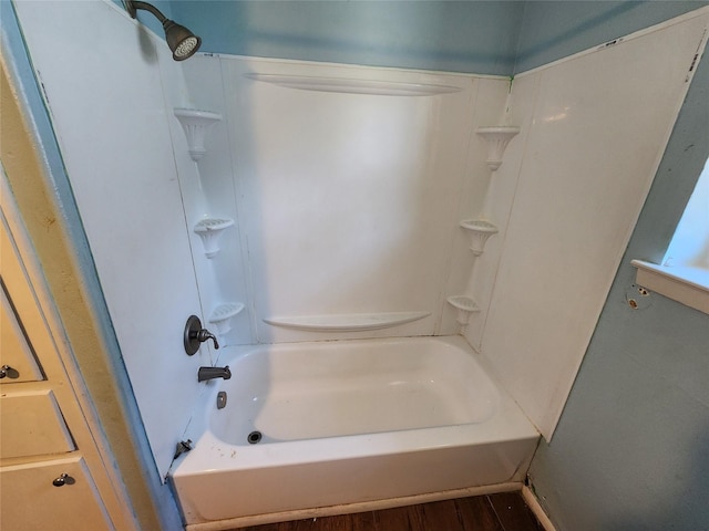 bathroom featuring tub / shower combination and wood finished floors
