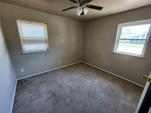 unfurnished room featuring carpet flooring, baseboards, and a ceiling fan