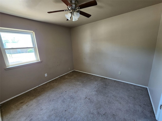 carpeted spare room with baseboards and ceiling fan
