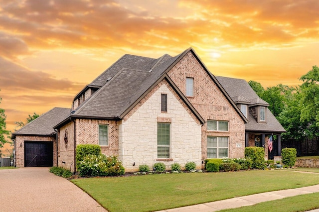 3 Asheville Ln, Trophy Club, TX 76262 - french country style house with brick siding, a yard, a shingled roof, concrete driveway, and stone siding