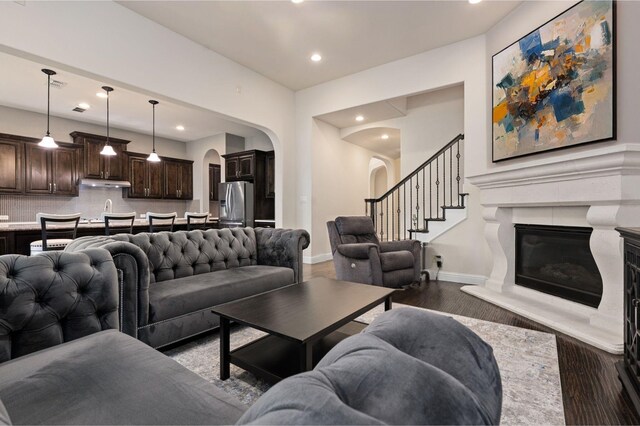 3 Asheville Ln, Trophy Club, TX 76262 - living room featuring arched walkways, a high end fireplace, baseboards, wood finished floors, and recessed lighting