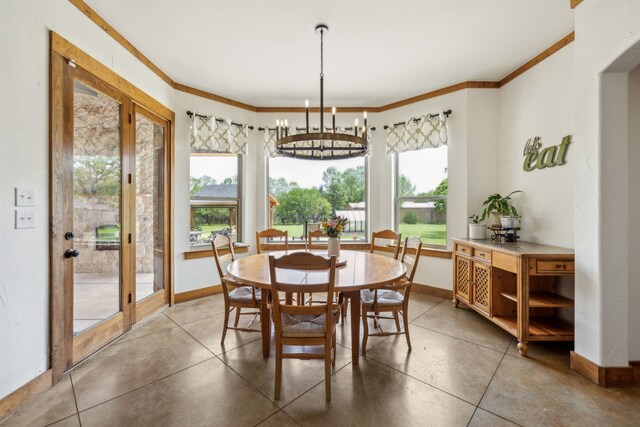 dining room featuring baseboards, ornamental molding, and a chandelier