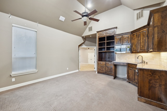4401 Sorrel Ct, Flower Mound, TX 75028 - kitchen featuring stainless steel microwave, a ceiling fan, light carpet, a sink, and dark brown cabinetry