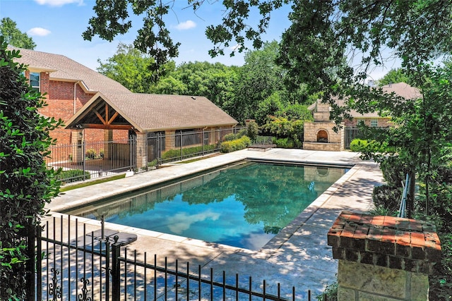 4401 Sorrel Ct, Flower Mound, TX 75028 - view of pool with an outdoor stone fireplace, fence, and a patio