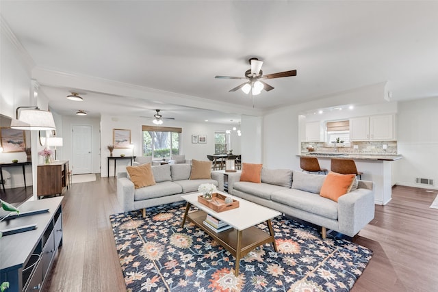 9375 Springwater Dr, Dallas, TX 75228 - living room featuring ceiling fan, light wood-style floors, and crown molding