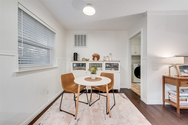 9375 Springwater Dr, Dallas, TX 75228 - dining room featuring washer / dryer, dark wood finished floors, and baseboards