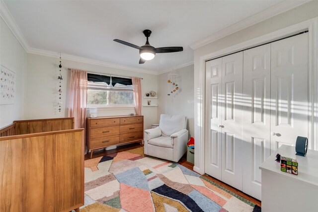 9375 Springwater Dr, Dallas, TX 75228 - bedroom featuring crown molding, light wood-style flooring, a closet, and ceiling fan