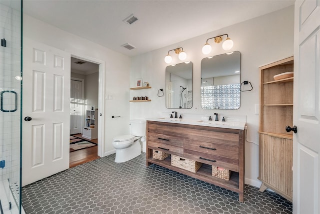9375 Springwater Dr, Dallas, TX 75228 - full bathroom featuring toilet, a stall shower, and double vanity
