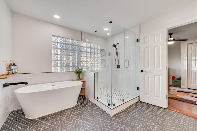 9375 Springwater Dr, Dallas, TX 75228 - full bathroom with tile walls, a freestanding bath, a shower stall, tile patterned floors, and wainscoting