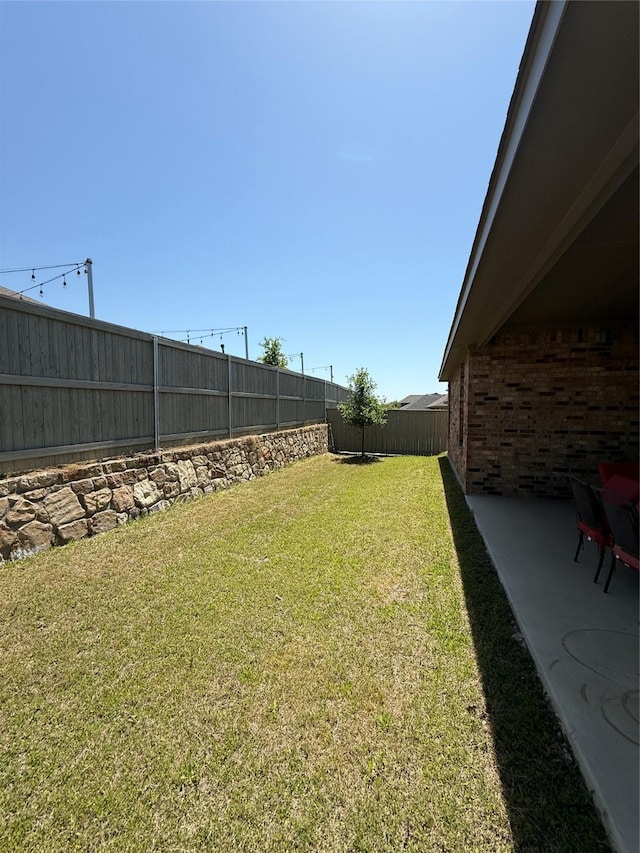view of yard featuring a patio and a fenced backyard