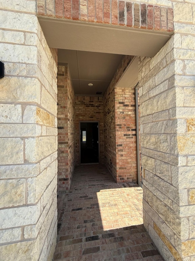 property entrance featuring brick siding