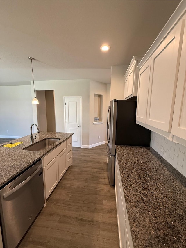 kitchen with decorative backsplash, dishwasher, a sink, and white cabinetry