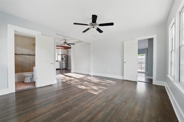 1101 Melbourne Ave, Dallas, TX 75224 - unfurnished bedroom with a ceiling fan, baseboards, dark wood-style floors, and connected bathroom