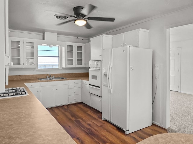 3103 Coggin Ave, Brownwood, TX 76801 - kitchen featuring glass insert cabinets, a sink, dark wood-style flooring, ceiling fan, and white appliances