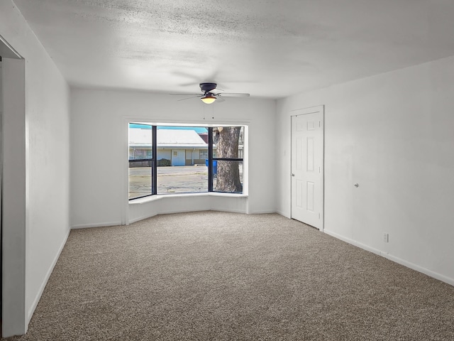 3103 Coggin Ave, Brownwood, TX 76801 - carpeted spare room with baseboards, a ceiling fan, and a textured ceiling
