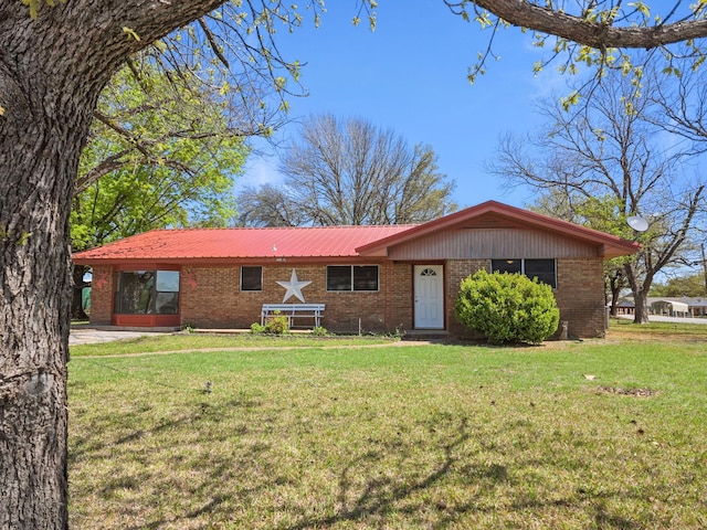 3103 Coggin Ave, Brownwood, TX 76801 - ranch-style home featuring metal roof, a front lawn, and brick siding