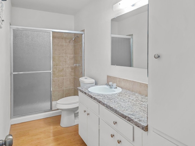 3103 Coggin Ave, Brownwood, TX 76801 - bathroom with toilet, vanity, a stall shower, and wood finished floors