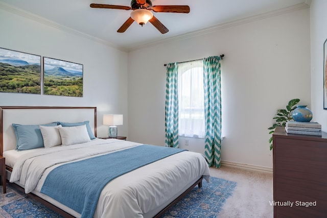 carpeted bedroom featuring ceiling fan, crown molding, and baseboards