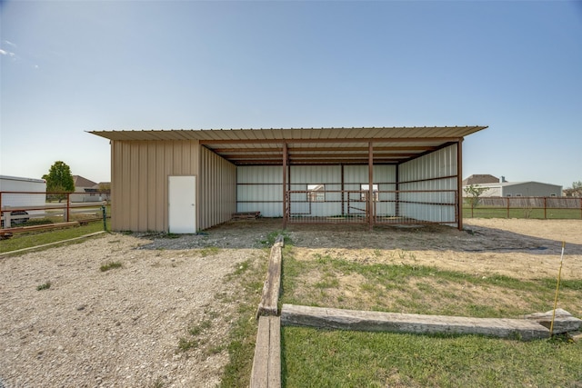 view of pole building featuring fence