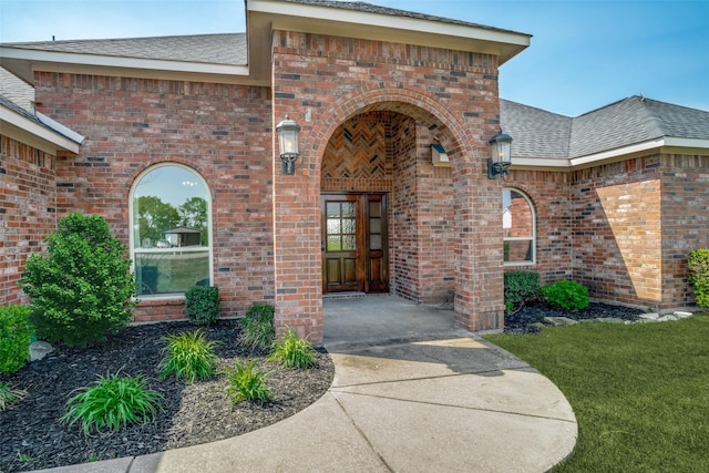 1656 Hearn Ln, Van Alstyne, TX 75495 - view of exterior entry with brick siding and roof with shingles
