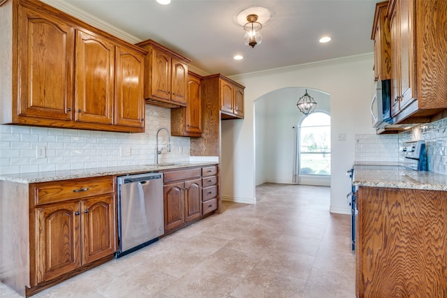 kitchen featuring arched walkways, light stone counters, stainless steel appliances, brown cabinets, and crown molding