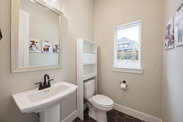 2720 Whirlaway Ct, Celina, TX 75009 - bathroom featuring toilet, tile patterned flooring, baseboards, and a sink