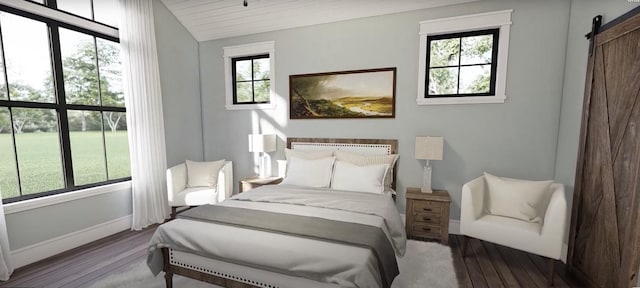 bedroom featuring a barn door, vaulted ceiling, wood finished floors, and baseboards
