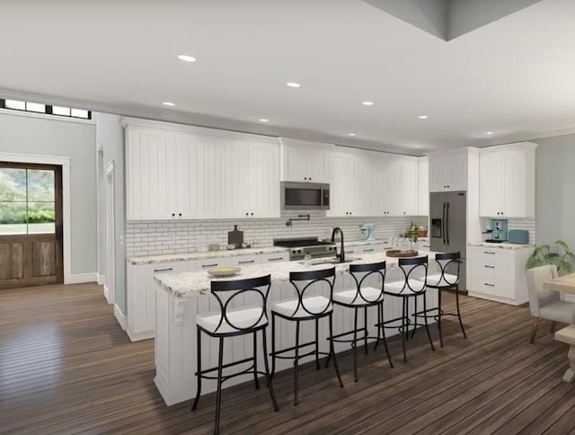 kitchen featuring a large island, dark wood finished floors, backsplash, and appliances with stainless steel finishes