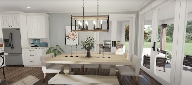dining space featuring dark wood finished floors, an inviting chandelier, crown molding, and french doors