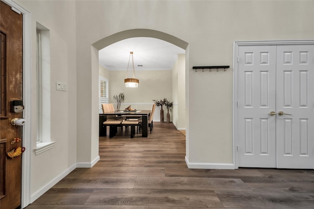 2325 Heather Ridge Dr, Flower Mound, TX 75028 - foyer entrance featuring arched walkways, dark wood-style flooring, baseboards, and ornamental molding